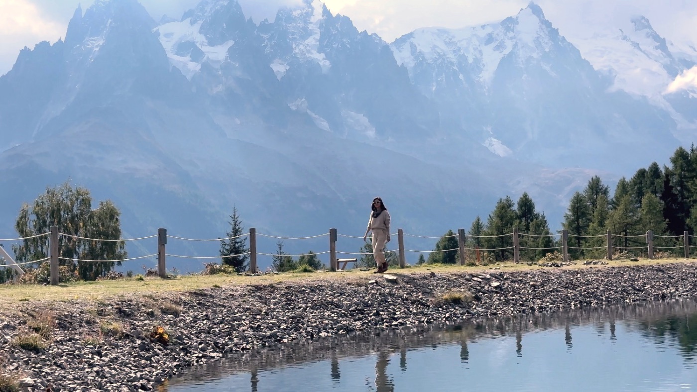 A still alpine lake ringed by snowy peaks