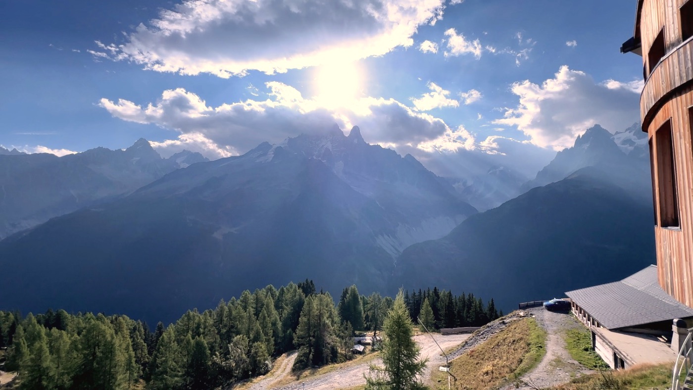 A burst of sun over the mountains from the hiking trail