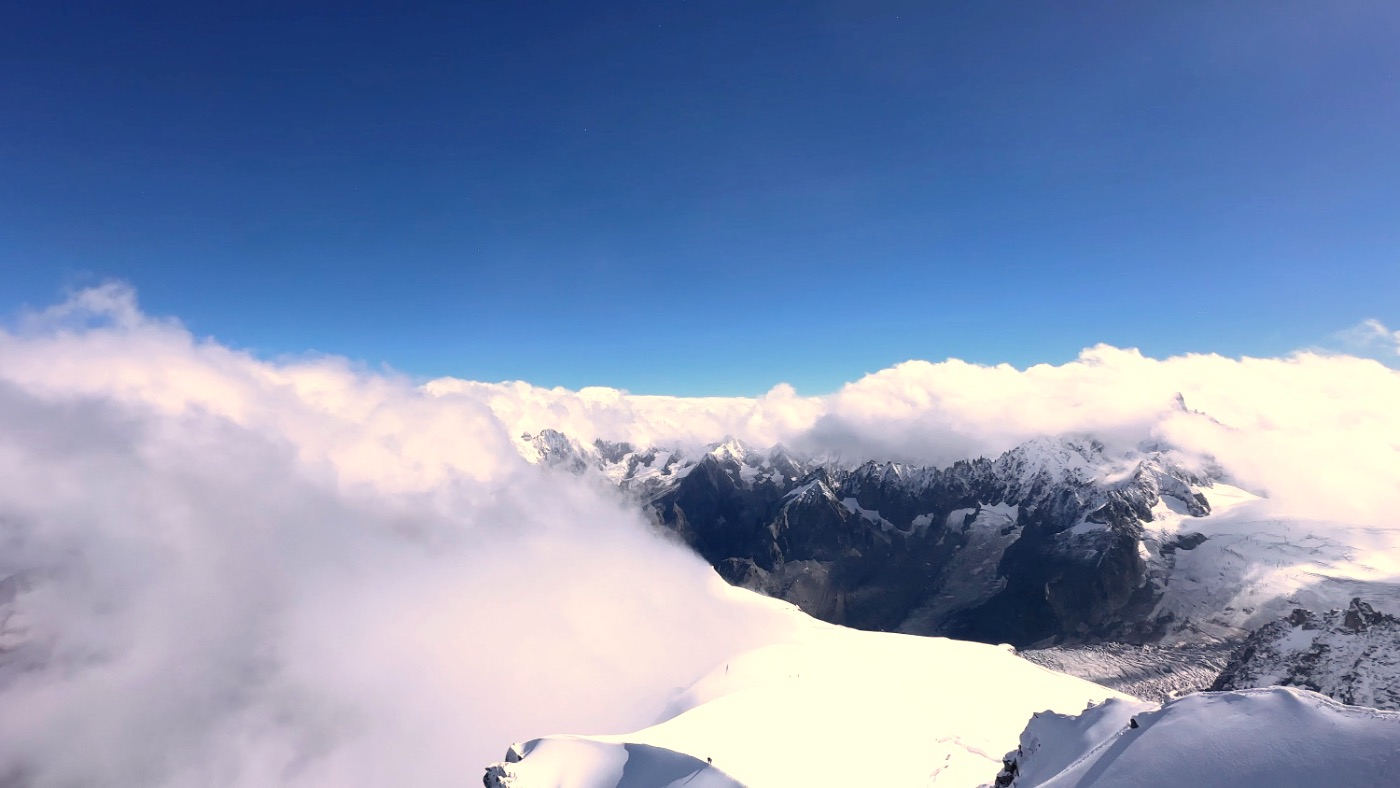 Snowy peaks rising above a sea of cloud