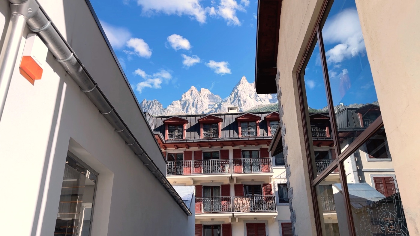 Mont Blanc's spires framed between buildings, seen from the hotel window