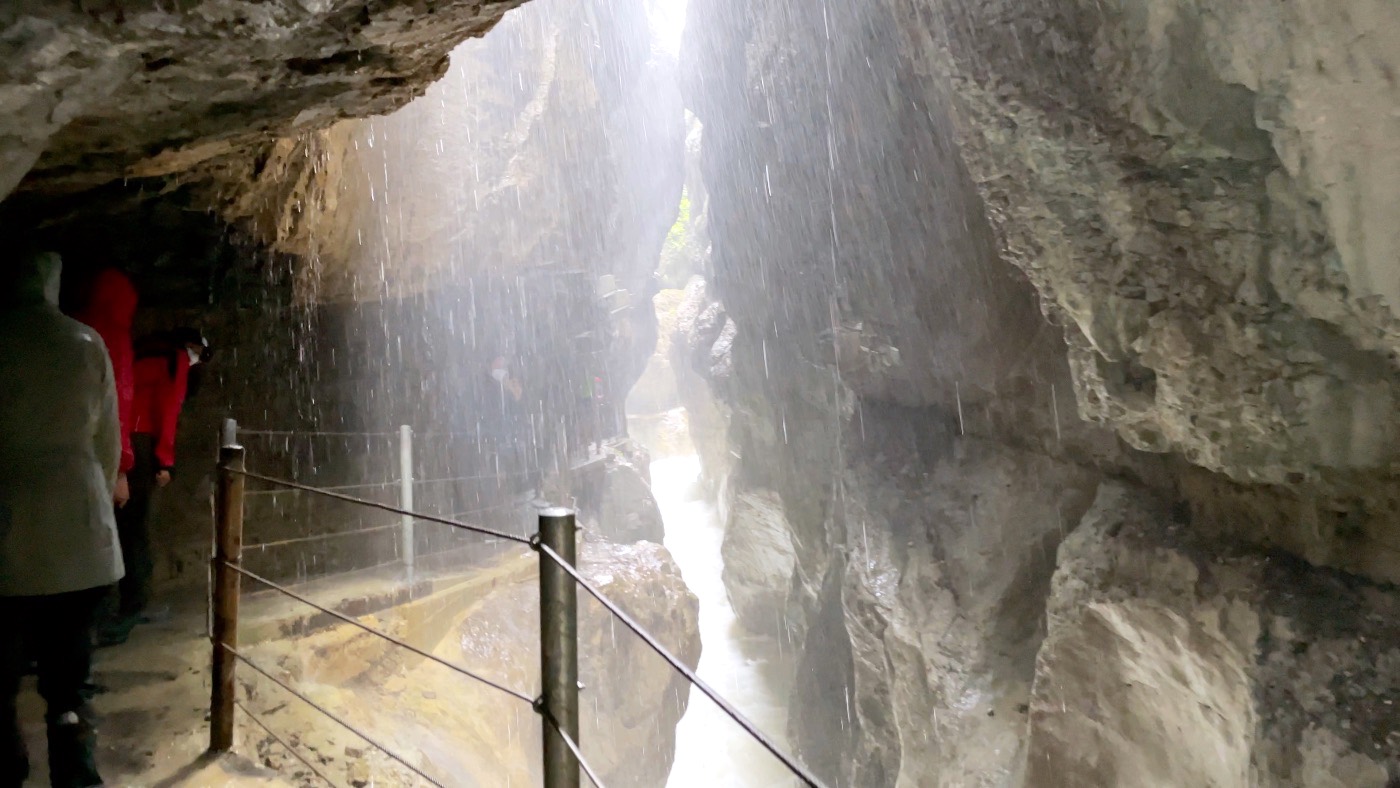Water pouring down the towering rock walls of the Partnach Gorge