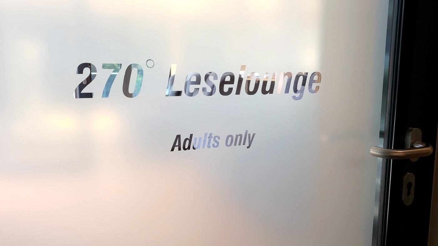 A frosted glass door etched with