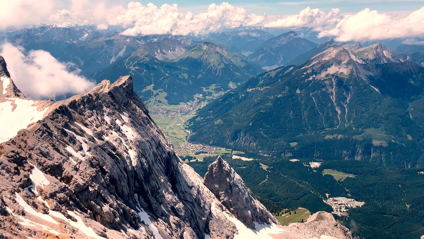 A jagged summit ridge with the green valley far below