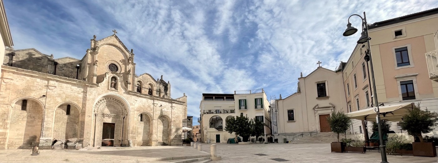 A wide view of Piazza San Giovanni in Matera, with the old stone church on the left