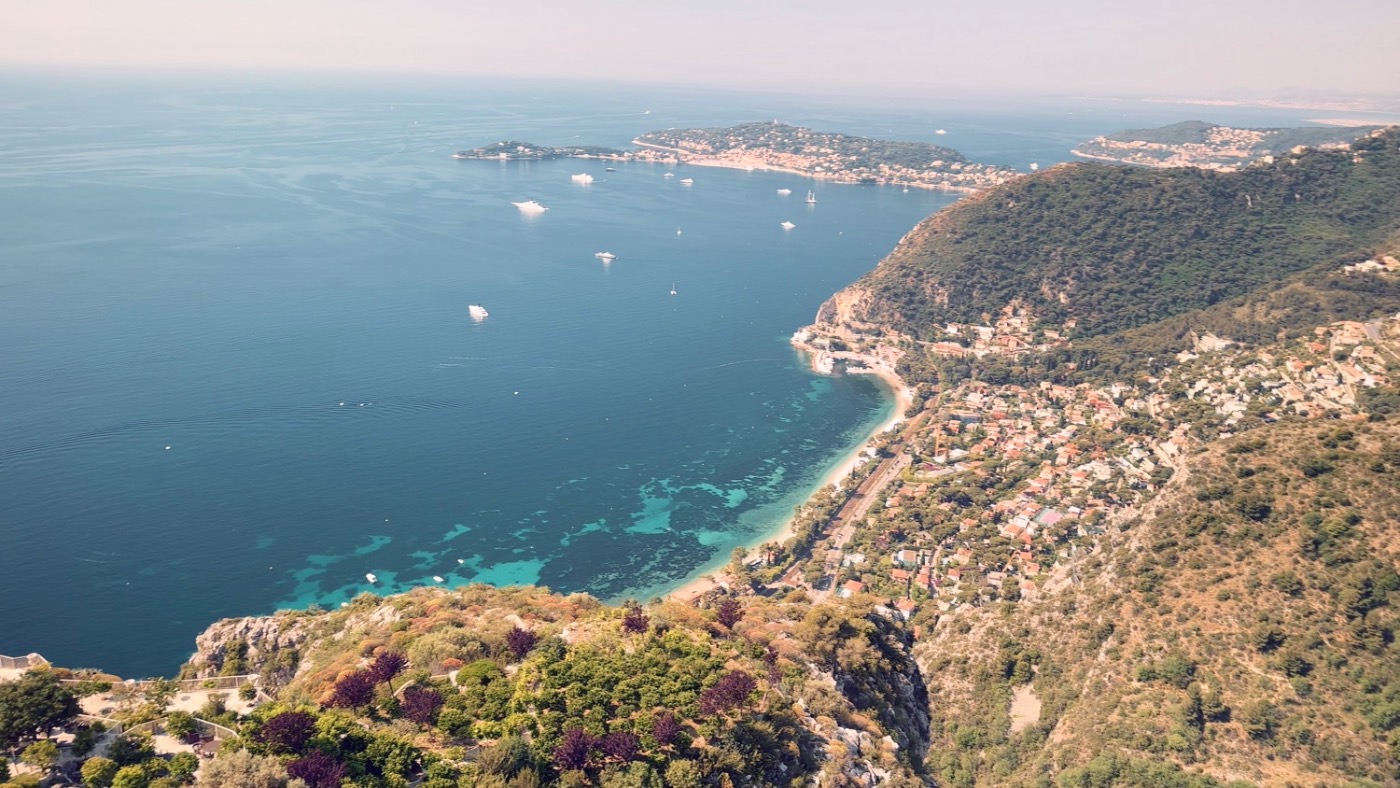 The sweeping Côte d'Azur view from the guests-only terrace — turquoise bays, Cap Ferrat, and yachts at anchor