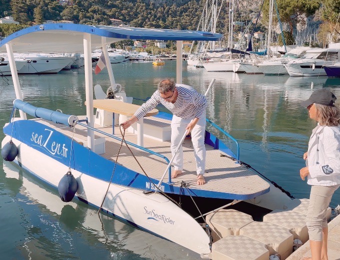 The little blue solar boat moored at the dock