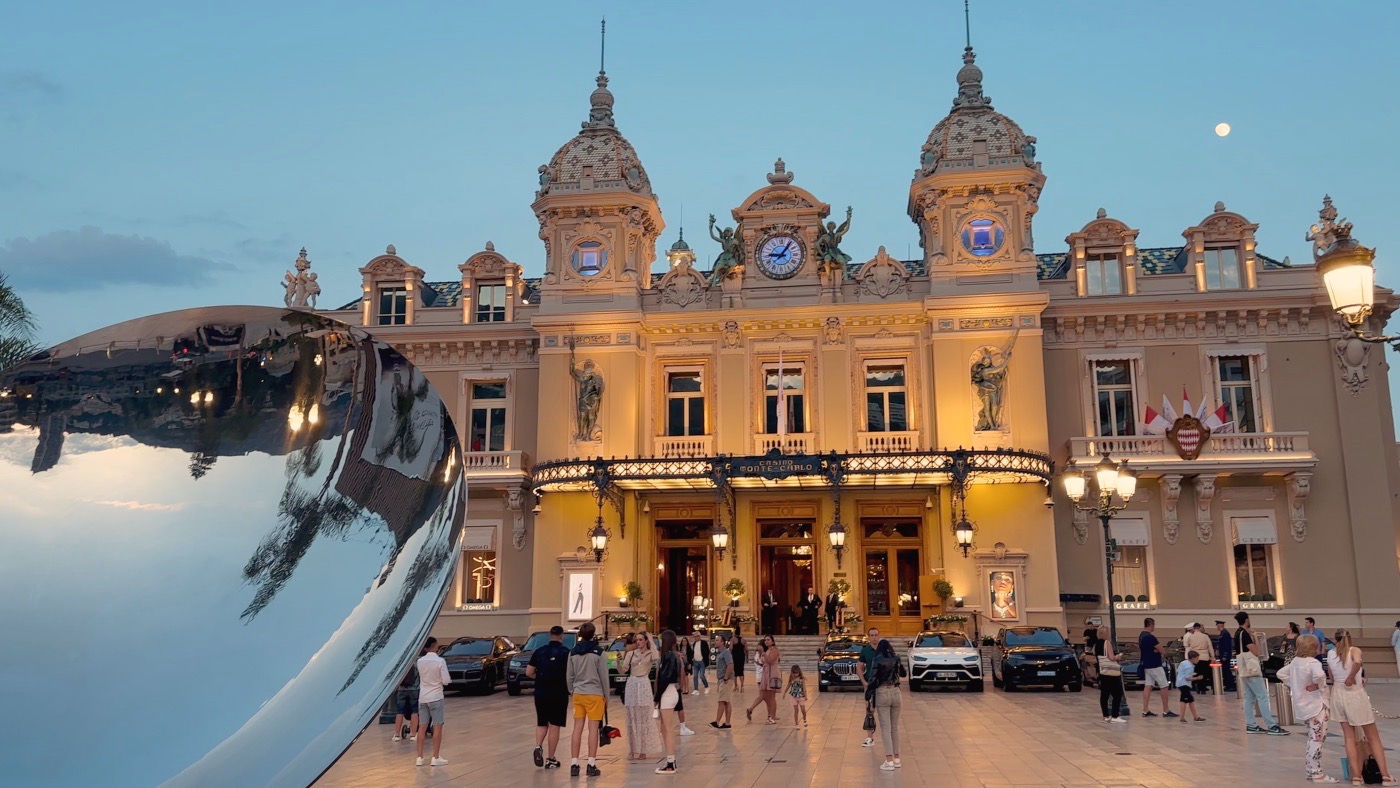 The lit facade of the Monte Carlo Casino at dusk