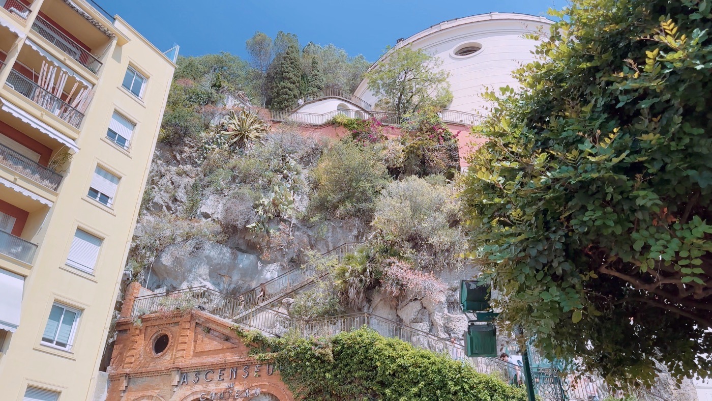 Looking up at Castel Hill in Nice, with its stairways, lush planting and the old Ascenseur du Château