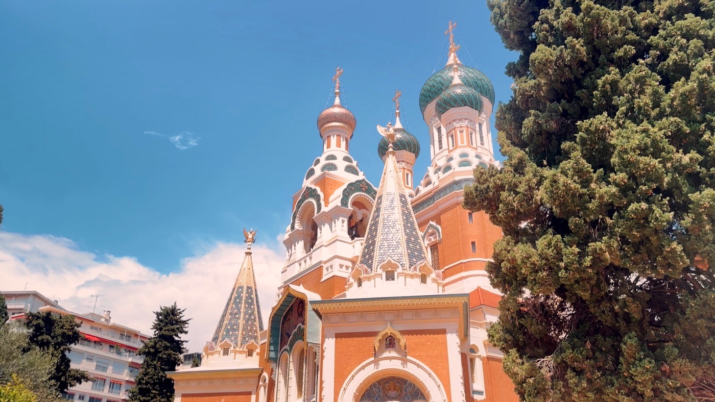 The onion domes of the Russian Orthodox Cathedral of Saint Nicholas in Nice against a blue sky