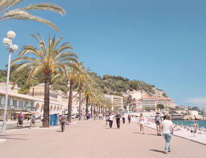 The palm-lined Promenade des Anglais in Nice, with strollers along the seafront