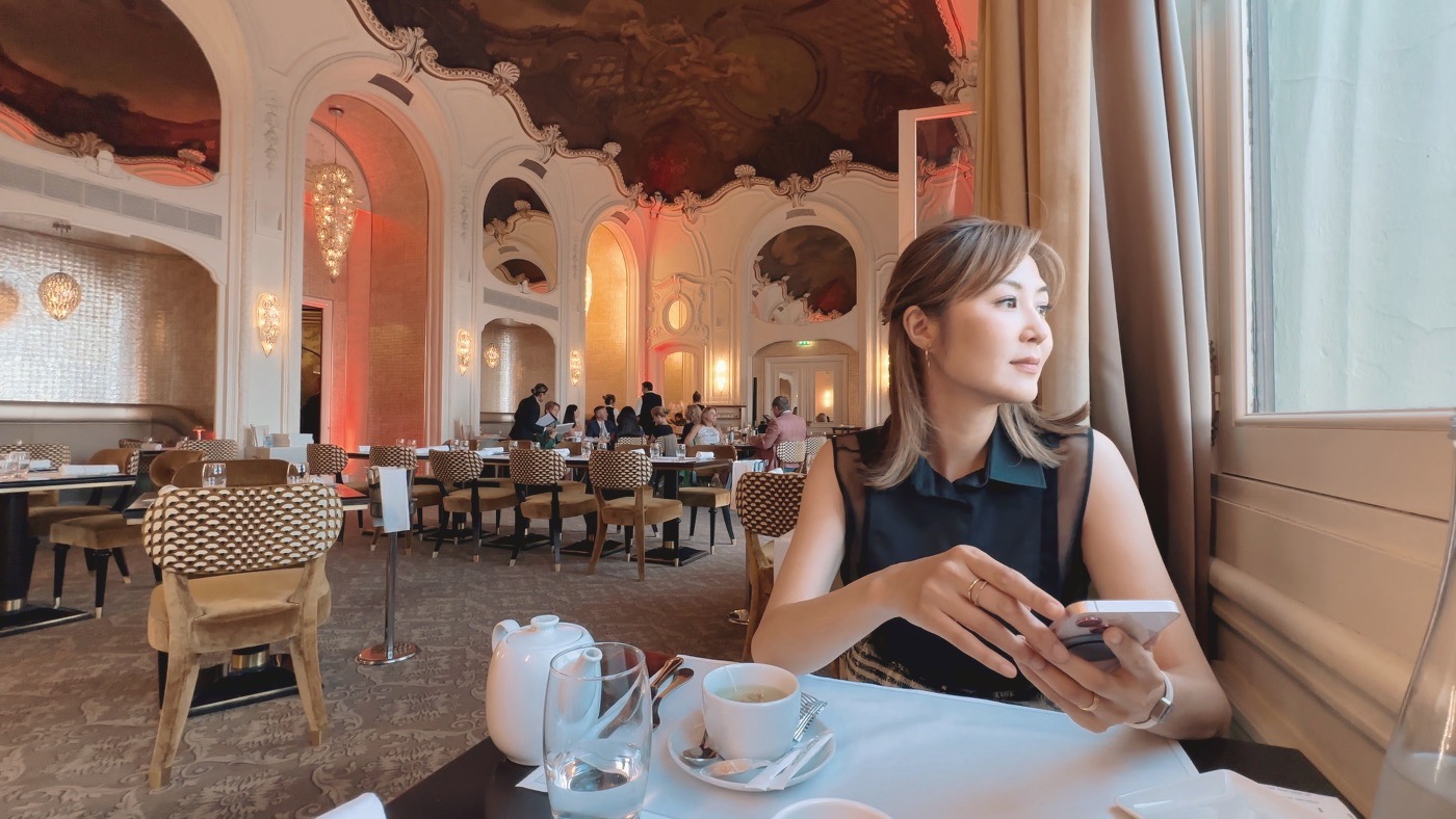 A woman by the window in the casino's ornate, fresco-ceilinged restaurant
